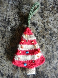 Tiny Tree Ornament https://www.allfreeknitting.com and look for 'Patterns for the Holidays'